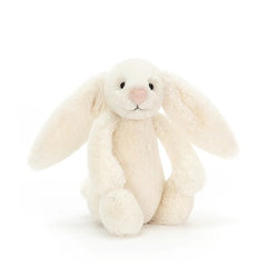 Cream-colored bunny plush toy on a white background
