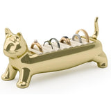 Gold cat-shaped ring holder with rings on a white background