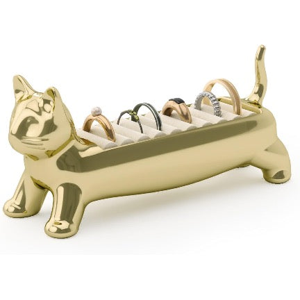 Gold cat-shaped ring holder with rings on a white background