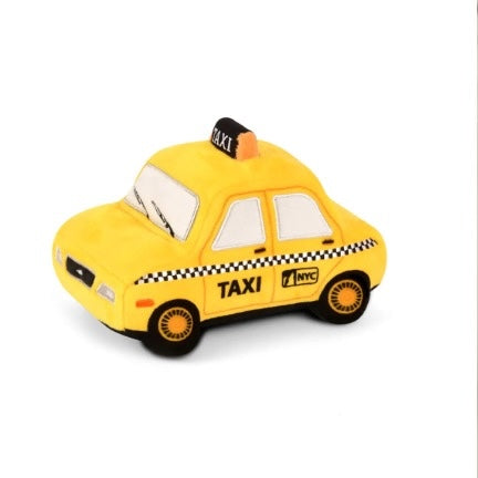 Yellow toy taxi with 'NYC' branding on a white background